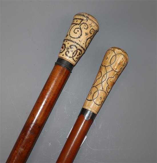 Two pique worked ivory handled canes longest 97cm